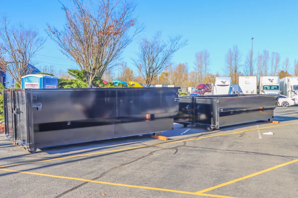 Professional dumpster rental service with roll-off container on residential driveway in McKeesport
